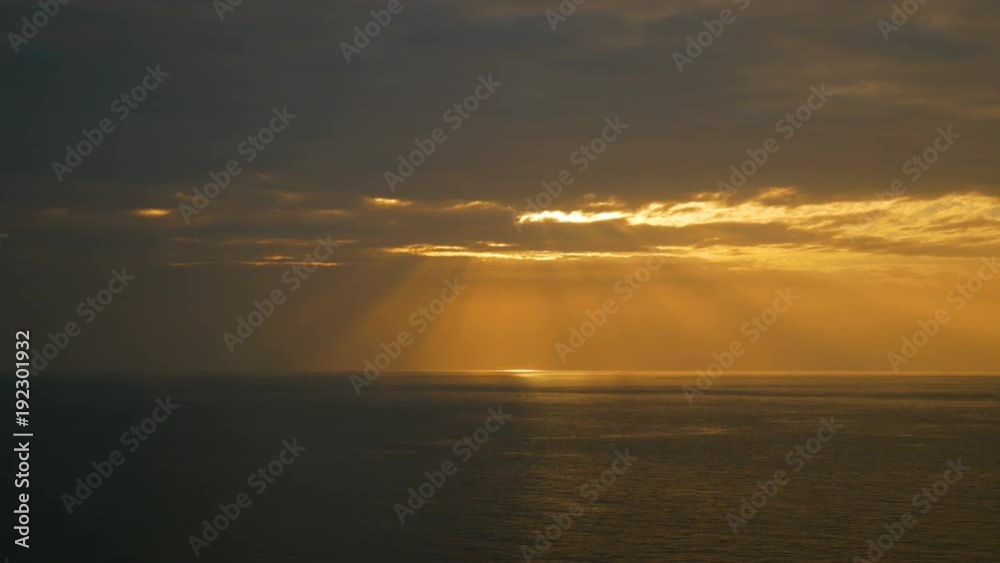 sun light beam from the sky at sunset time over the sea wave sun light beam from the sky at sunset time over the sea wave