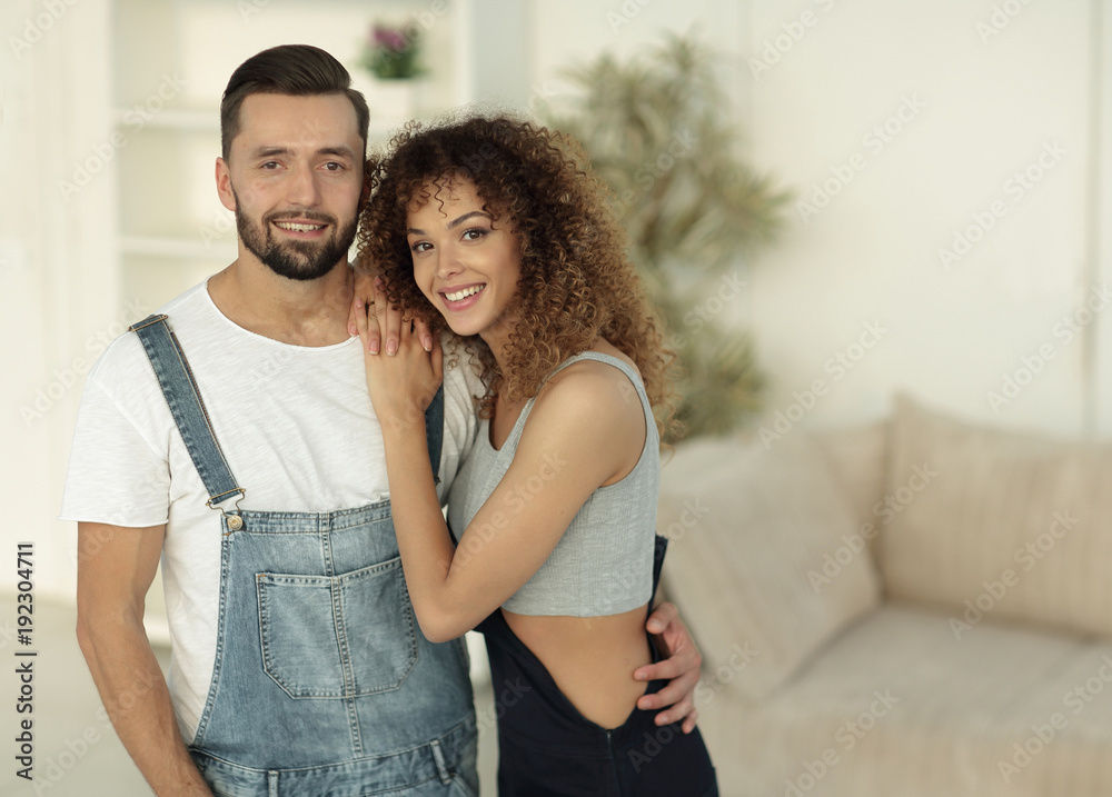 Fototapeta premium Happy young people standing in a new house