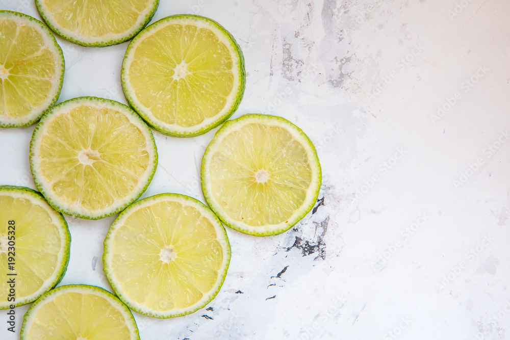 Lime slices in rows on a light background copy space Lime slices in rows on a light background copy space