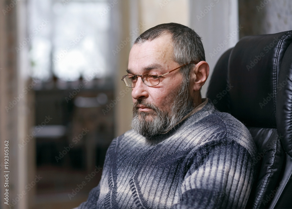 A man with a beard in a chair A man with a beard in a chair