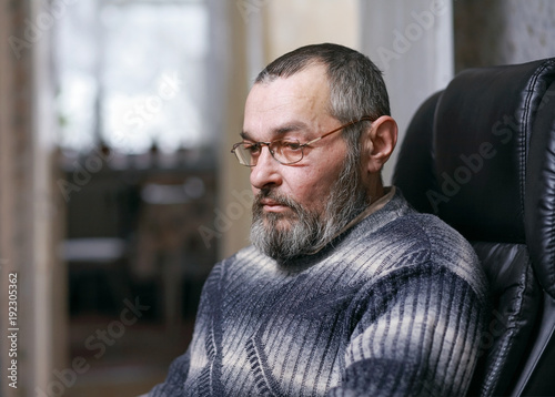 A man with a beard in a chair
