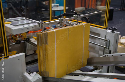 Automatic carton erector machine. Industrial warehouse machinery photo