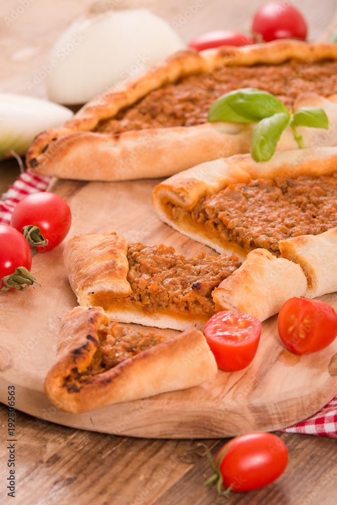 Turkish pide pizza with meat and onion.