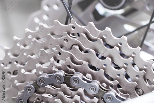 Bicycle gear and disk brake detail, close up shot of new and clean silver mountainbike metal chain rings