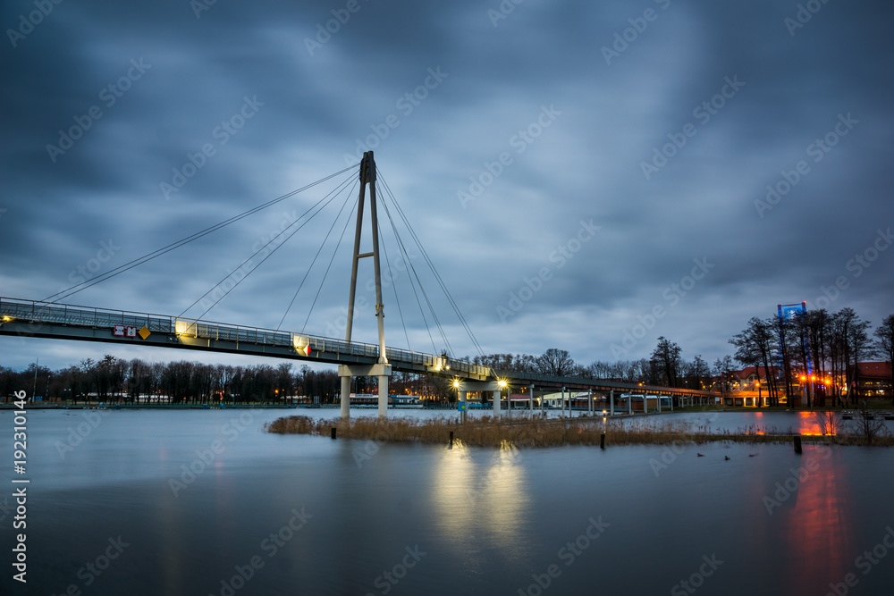 Pier at the Niegocin lake and rainy clouds at night in Gizycko, Masuria, Poland