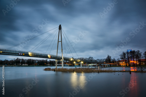 Fototapeta Naklejka Na Ścianę i Meble -  Pier at the Niegocin lake and rainy clouds at night in Gizycko, Masuria, Poland