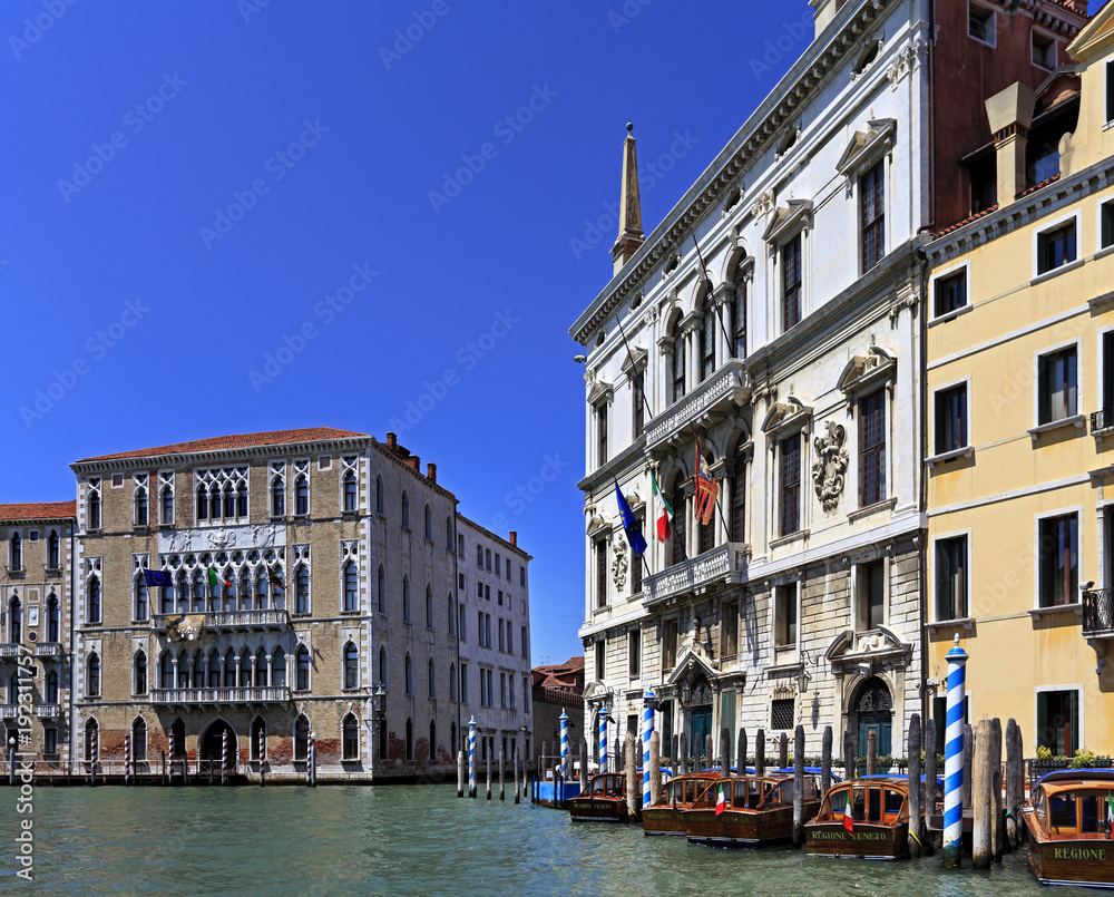 Venice historic city center, Veneto rigion, Italy - view on the Palazzo residences with vaporetto water taxis and gondolas on the Grand Canal