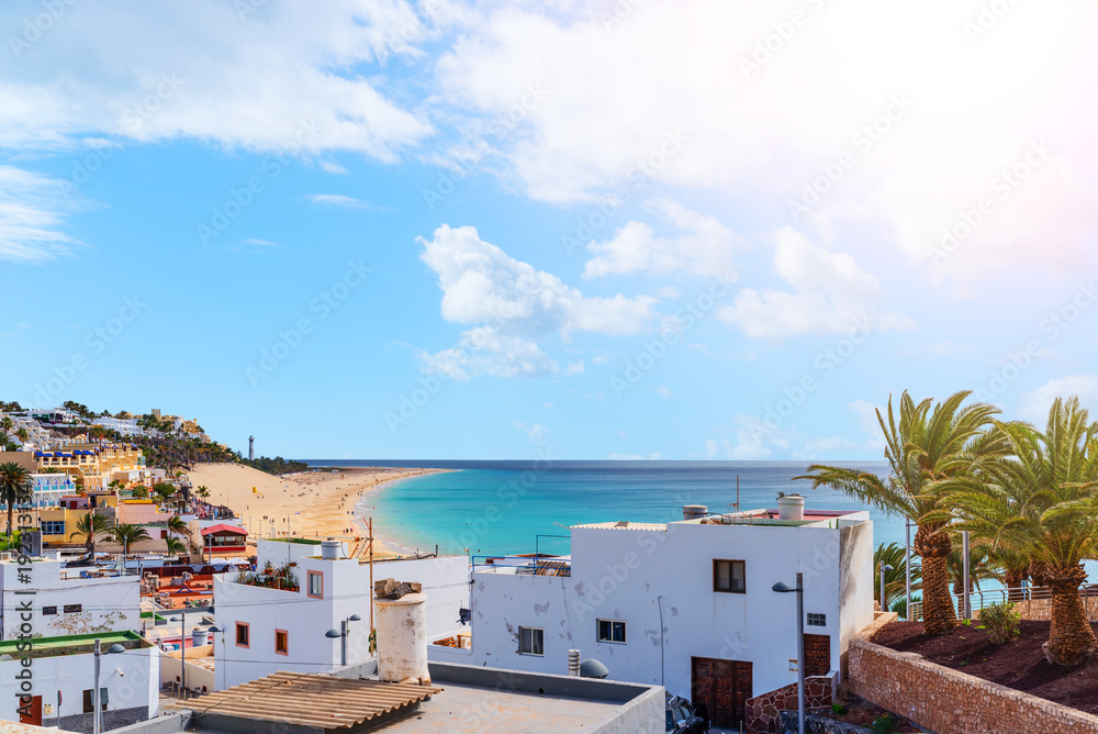 Fototapeta premium high angle view over town of Morro Jable and tourist resort on Fuerteventura island with beach and ocean under beautiful sky