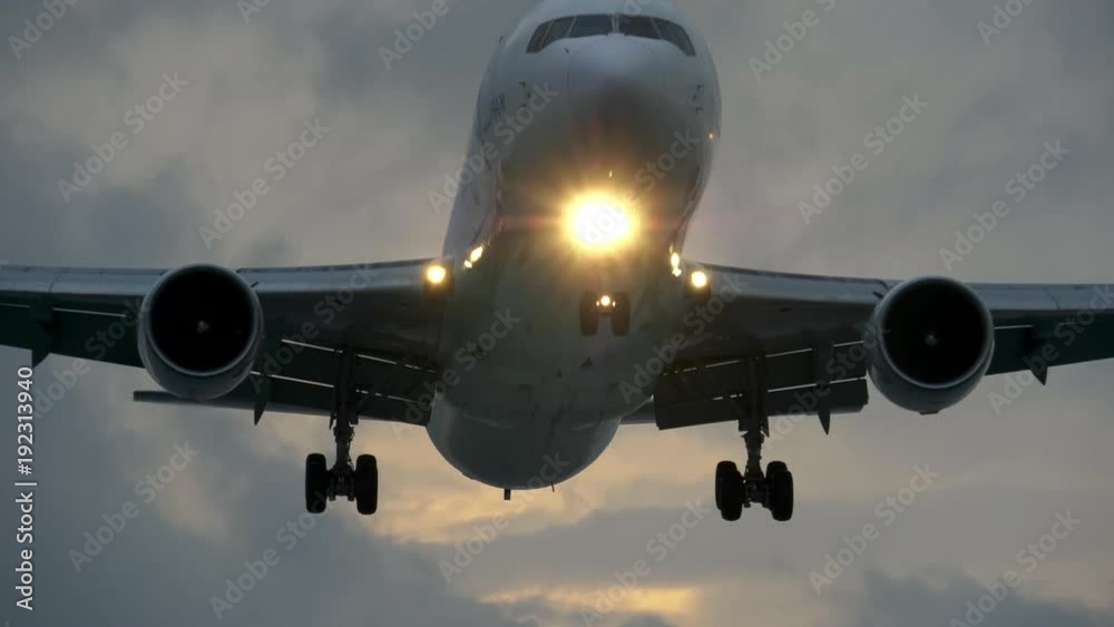 Commercial jet plane approach landing at dusk. 4K, UHD