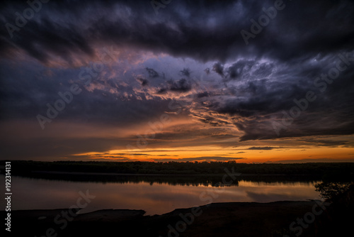 Dramatic sunset clouds near a river