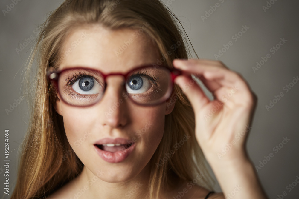 Huge blue eyed young woman in surprise, studio Huge blue eyed young woman in surprise, studio