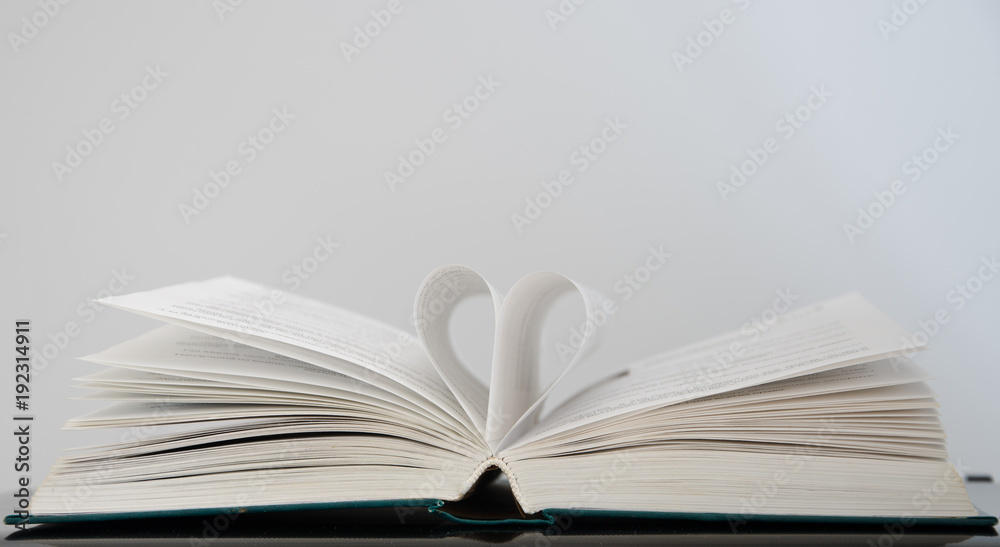 Open book with heart from the pages on a white background Open book with heart from the pages on a white background