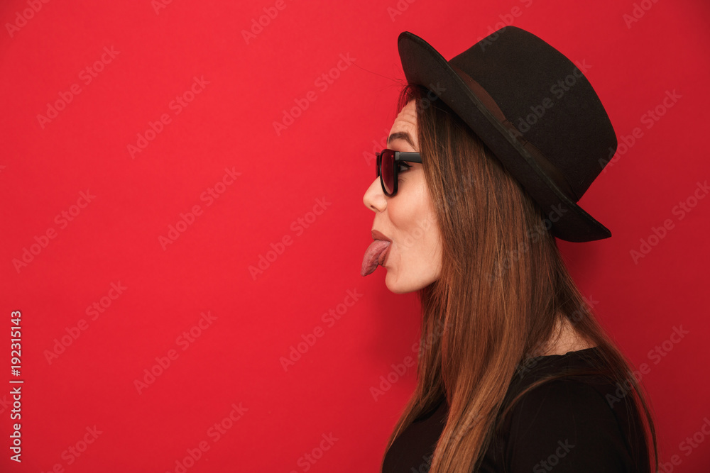 Cute young woman showing tongue. Cute young woman showing tongue.