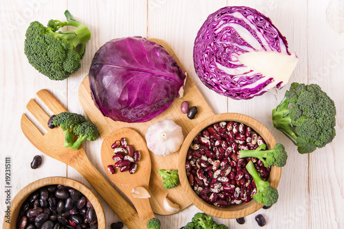 Red cabbage,broccoli,garlic and kidney beans.white wooden table.top view.vegetable assortment