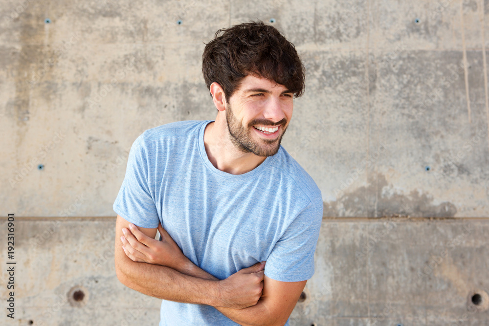 handsome young man with beard laughing