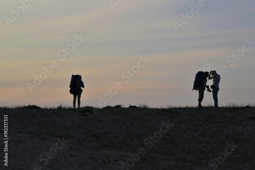 young people, tourists on the dark ground plane one woman and two silhouettes of men, concept of loneliness, rejection and love, the urge to travel Lake Baikal Olkhon Khuzhir town