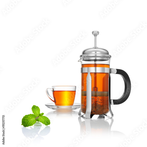 close up view of french press and a cup of black tea on white background