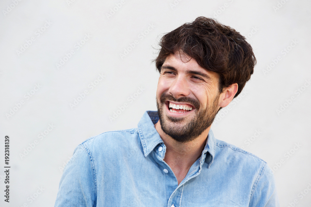 smiling man with beard against white background