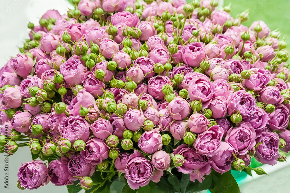 A huge bouquet of small pink roses of modern varieties in the bouquet as a gift. Background. Selective focus.