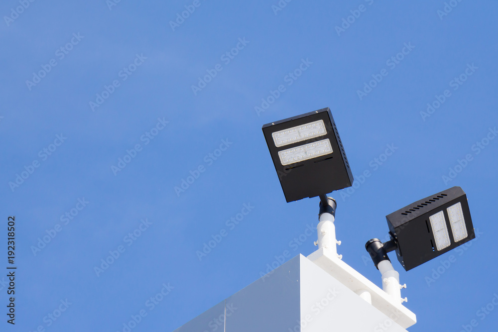 outdoor spotlight on top of the roof against blue sky, building lighting, house lighting outdoor spotlight on top of the roof against blue sky, building lighting, house lighting