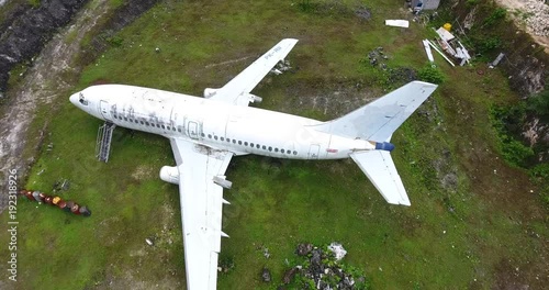 Wallpaper Mural Rising crane shot of old unused commercial plane in a small town of Kuta in Bali Torontodigital.ca