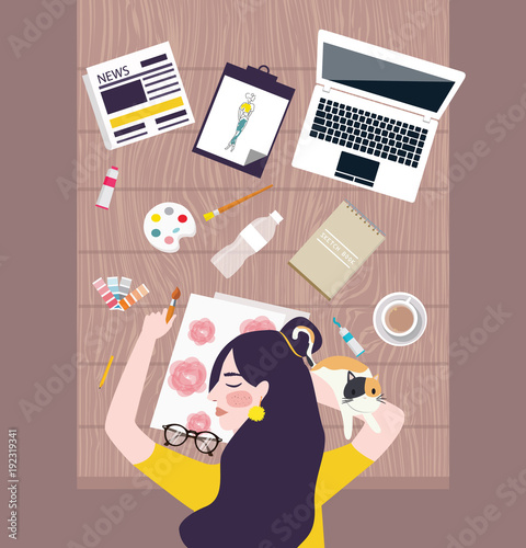 Busy woman designer artist taking a nap on working table with water color laptop and stuff all around
