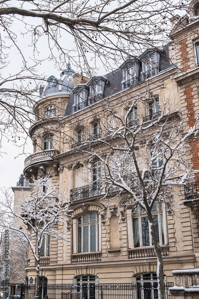 Paris under the snow, beautiful facades in winter
