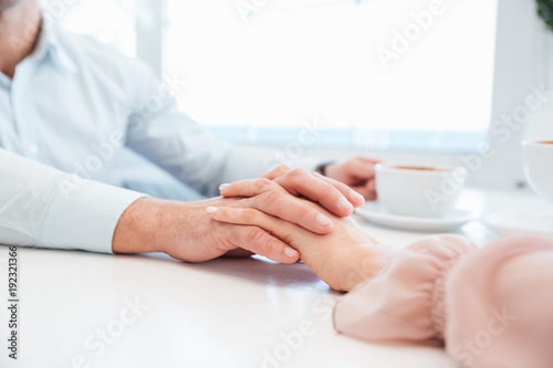 Cropped image of sensual lovely couple holding hand each other