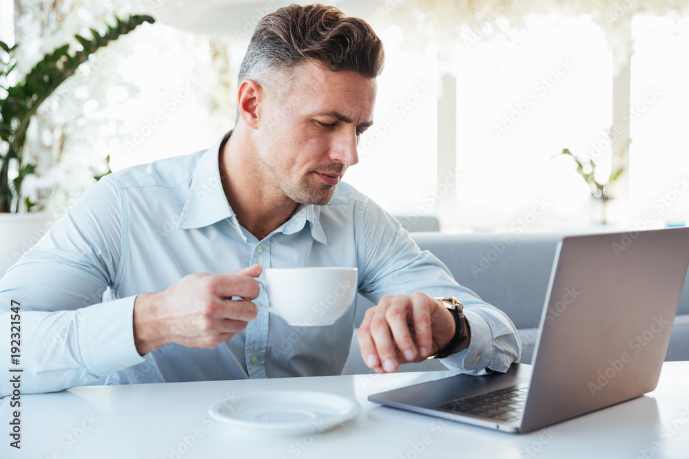 Portrait of a charming mature man using laptop computer Portrait of a charming mature man using laptop computer