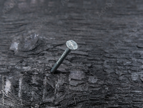 Metal nail close up on wooben background