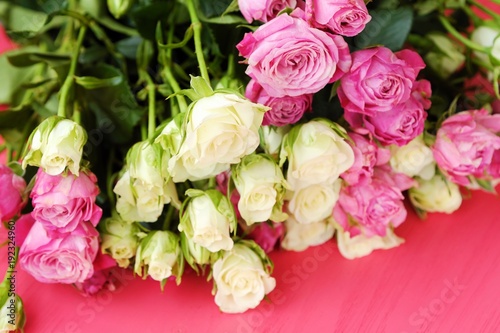 Beautiful bouquet of white and pink roses on pink background 