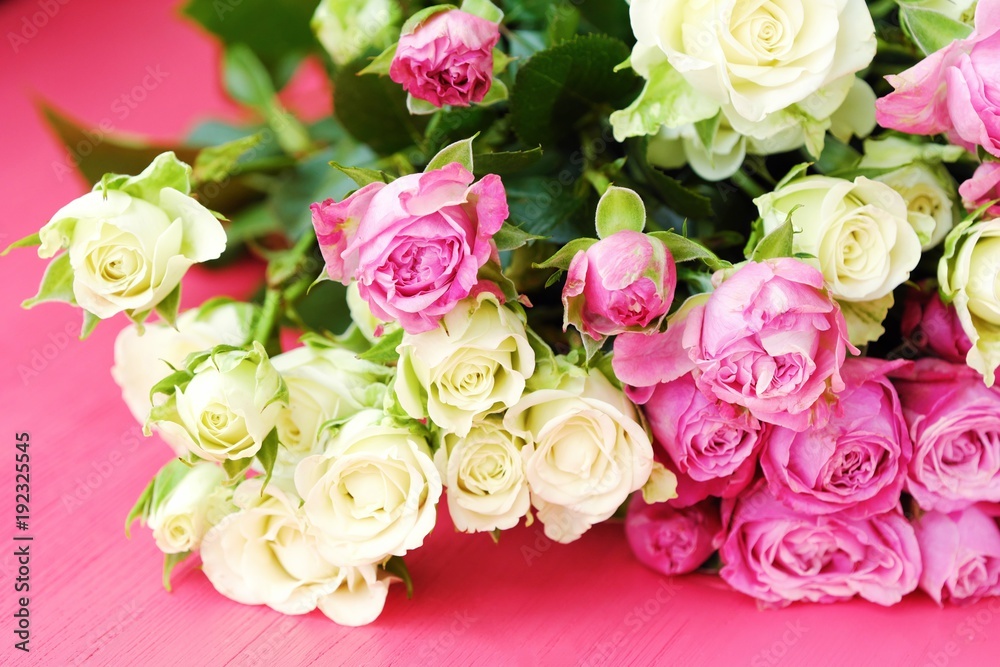 Beautiful bouquet of white and pink roses on pink background  