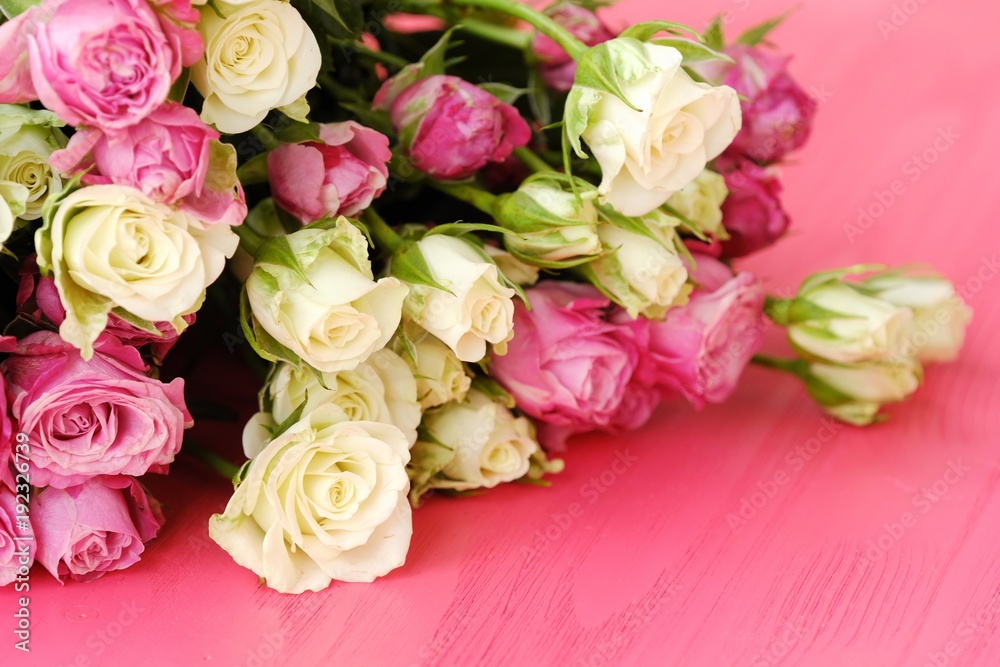 Fototapeta premium Beautiful bouquet of white and pink roses on pink background 