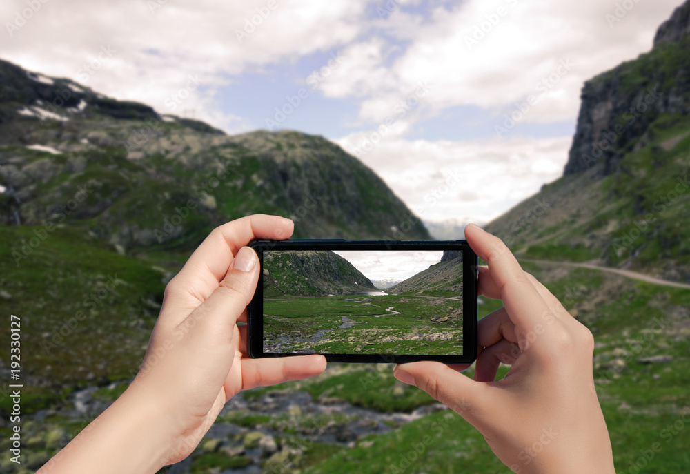 Picture of Norway on mobile phone. Female take photo of Suleskard on smart phone