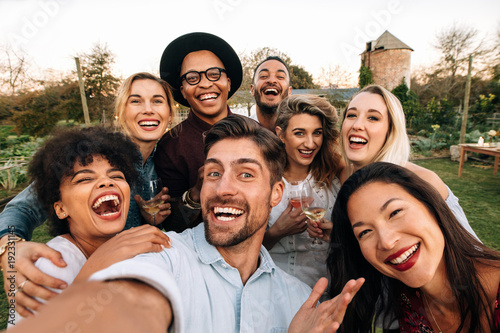 Friends making a selfie together at party photo