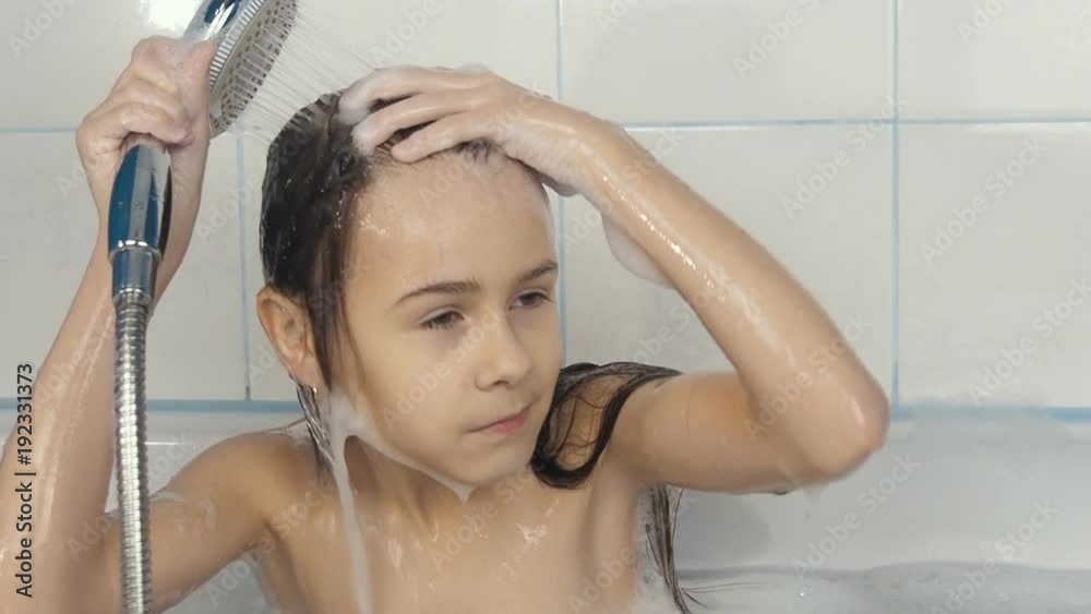 Child in the bathroom. A little girl in the shower. Child in the bathroom. A little girl in the shower.