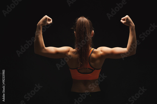 Athletic woman showing muscular body