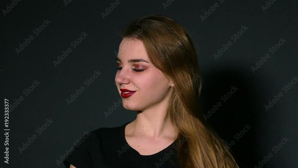 Young pleasant girl waves hair. Slow motion Young pleasant girl waves hair. Slow motion