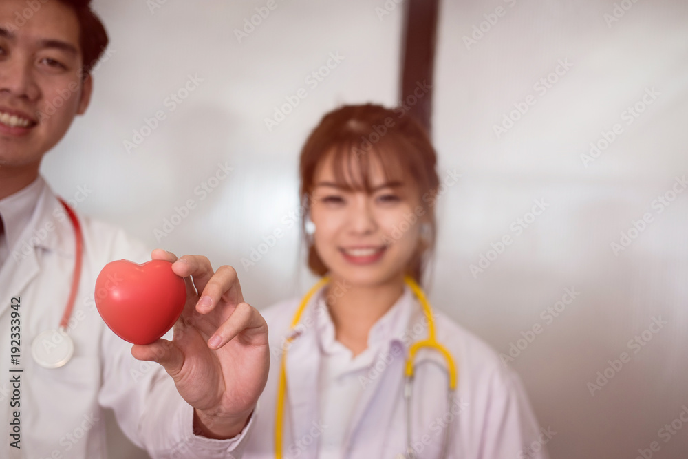 doctor holding red heart at hospital. medical, healthcare, cardiology concept doctor holding red heart at hospital. medical, healthcare, cardiology concept