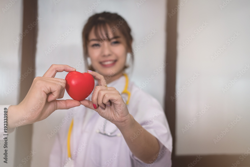 doctor holding red heart at hospital. medical, healthcare, cardiology concept doctor holding red heart at hospital. medical, healthcare, cardiology concept