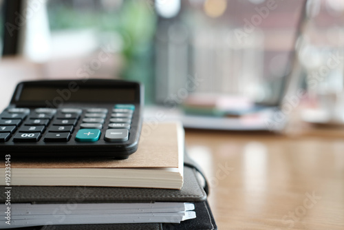 calculator, notebook on wood desk at office workplace. business, workspace, education concept.