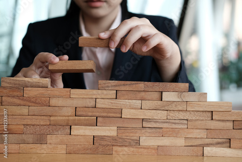 hand stacking wood block. growth, success & development in business