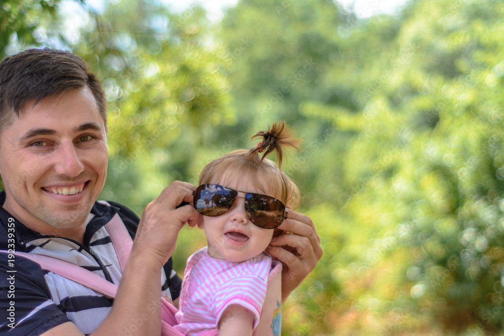 Amazing little girl is playing with sunglasses with her father Amazing little girl is playing with sunglasses with her father
