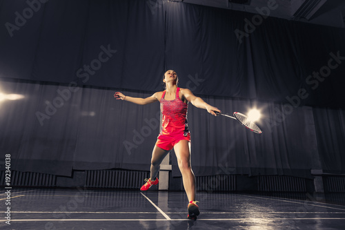 Young woman playing badminton at gym © master1305