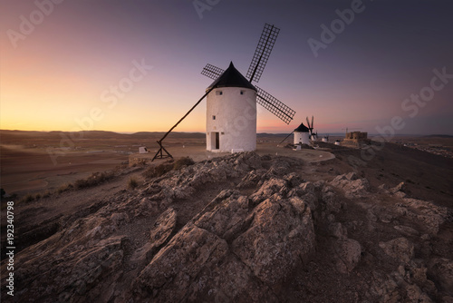 Don Quixote windmills at sunset. Famous landmark in Consuegra, Toledo Spain. photo