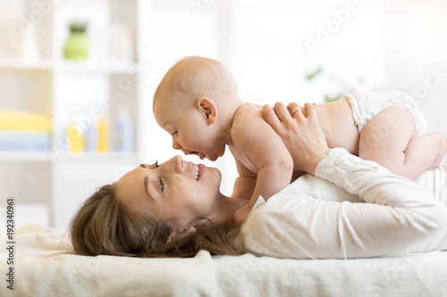 happy mother holding and pl...