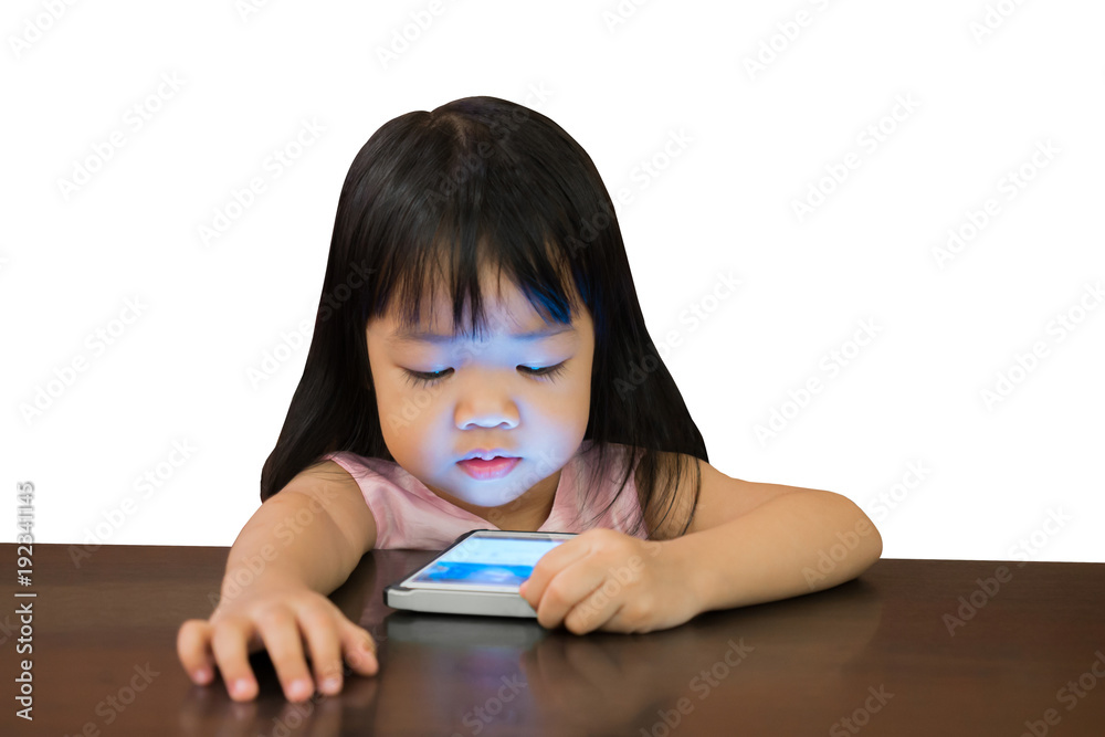 Little asian girl watching mobile phone on white background with clipping path Little asian girl watching mobile phone on white background with clipping path