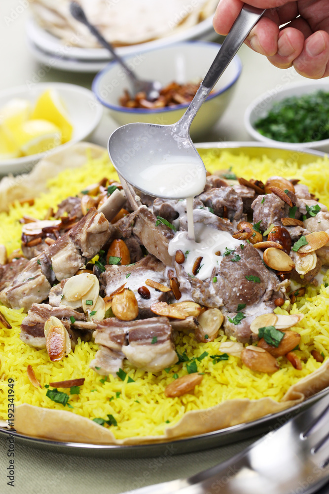 mansaf, Jordanian national dish, pouring yogurt sauce Stock Photo Adobe Stock
