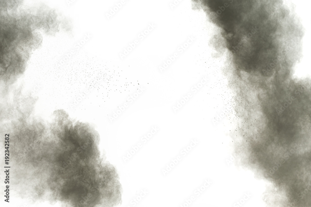 Black powder explosion against white background.The particles of charcoal splatted on white background. Closeup of black dust particles explode isolated on white background. Black powder explosion against white background.The particles of charcoal splatted on white background. Closeup of black dust particles explode isolated on white background.