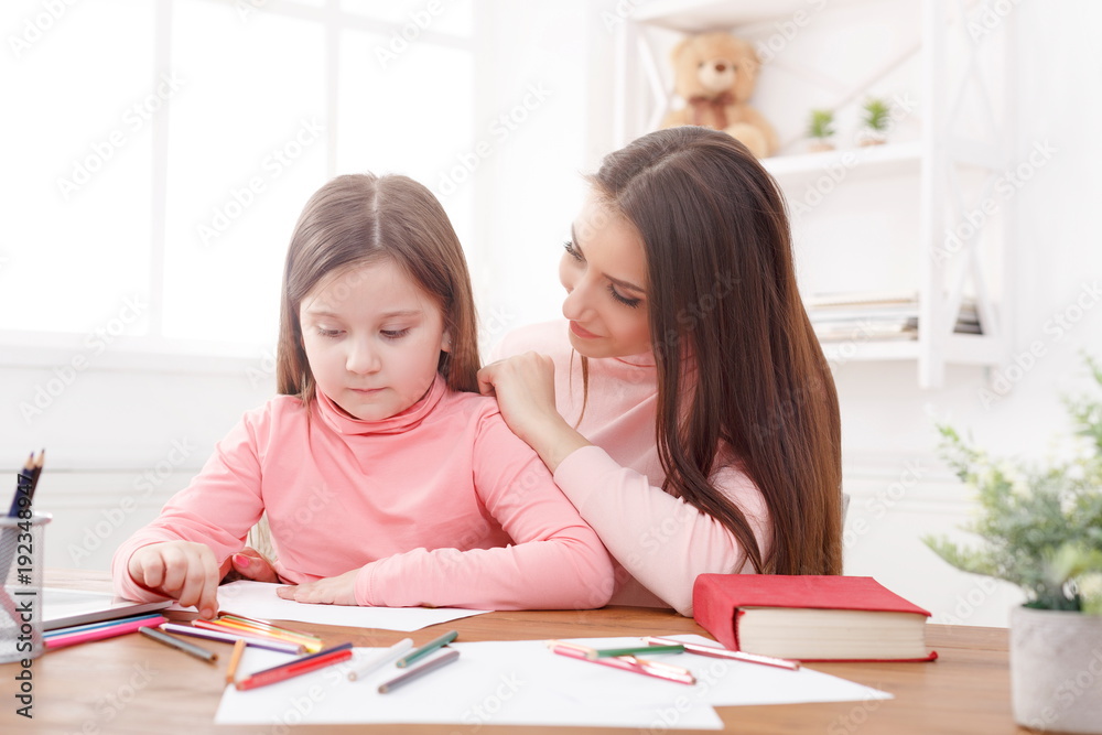 Mother drawing with her daughter Mother drawing with her daughter